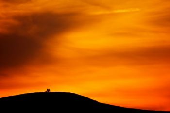 A couple enjoys a South Dakota sunset from atop Spirit Mound.