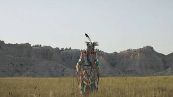 Adrian Primeaux wears traditional grass dance regalia during a video shoot in the Badlands.